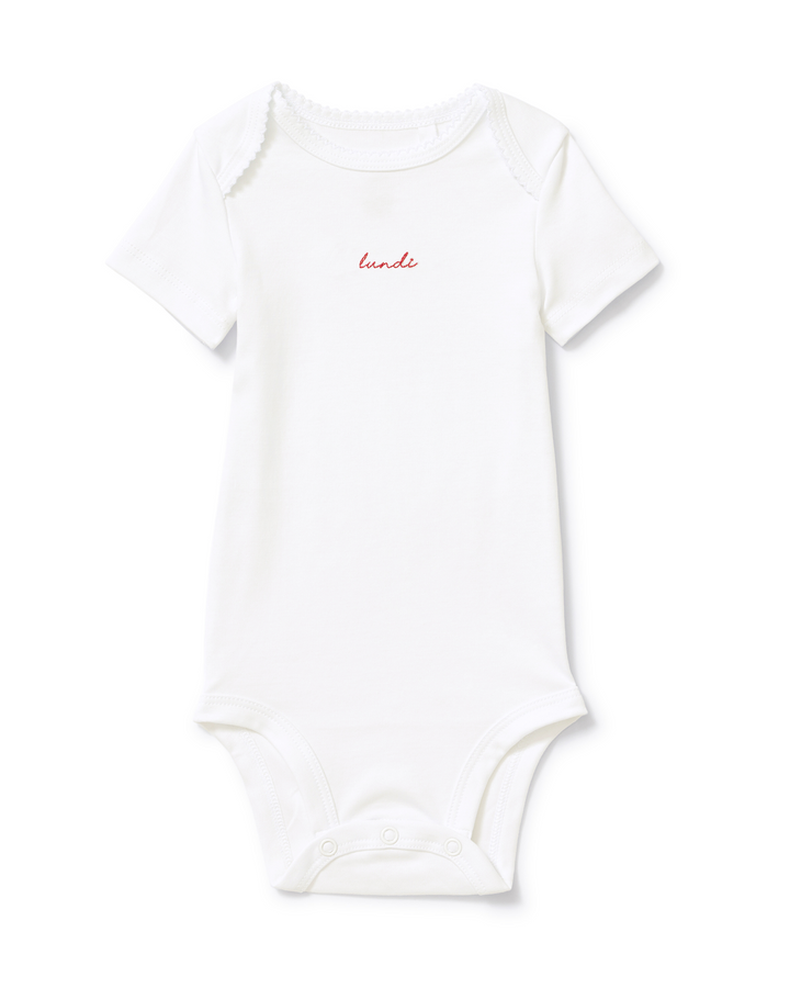 A white short-sleeve baby bodysuit with a small black script logo reading 'lundi' on the chest, displayed flat against a clean white background.