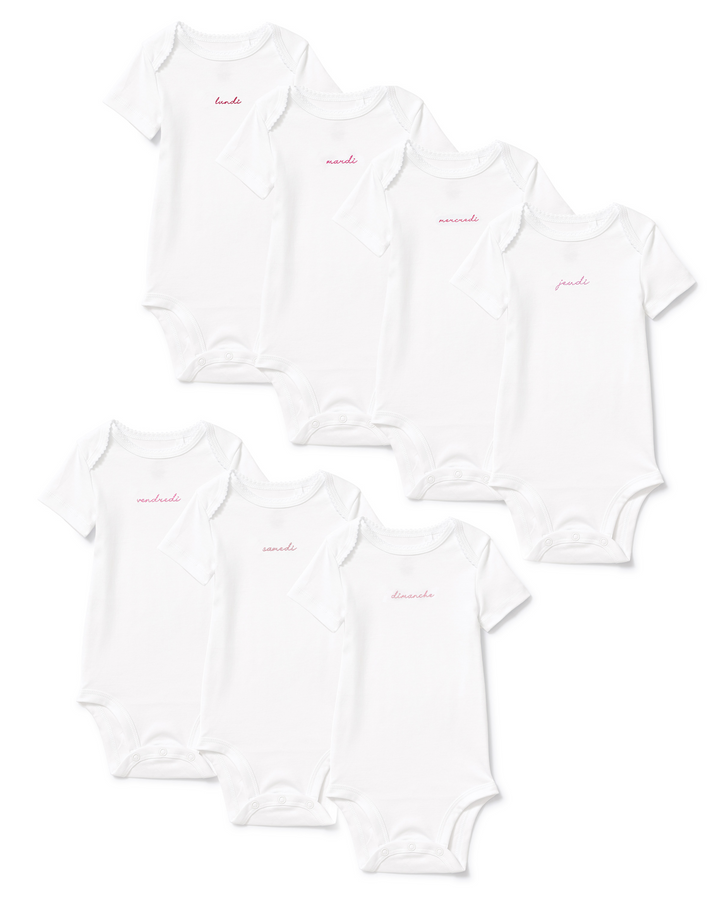Six white short-sleeve baby bodysuits in two sizes, each with the word 'amanda' printed in small pink script on the chest, arranged on a white background.