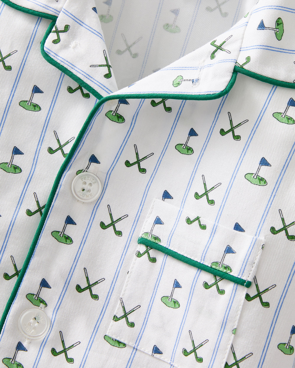 Close-up of a shirt with golf-themed pattern on a white background