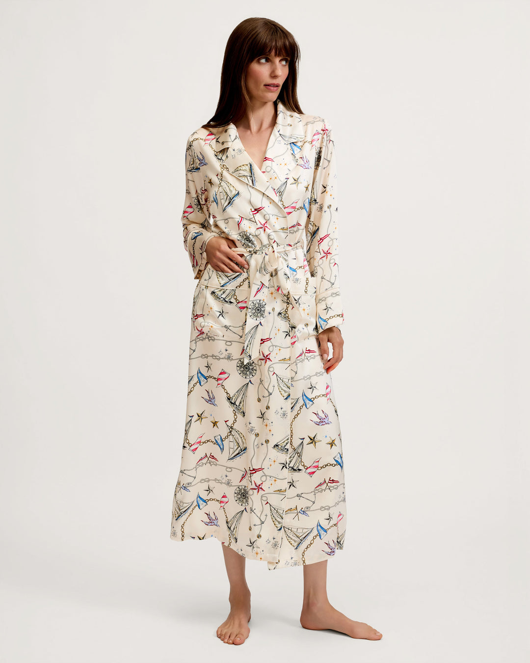 Women wearing a nautical print silk robe in front of white background