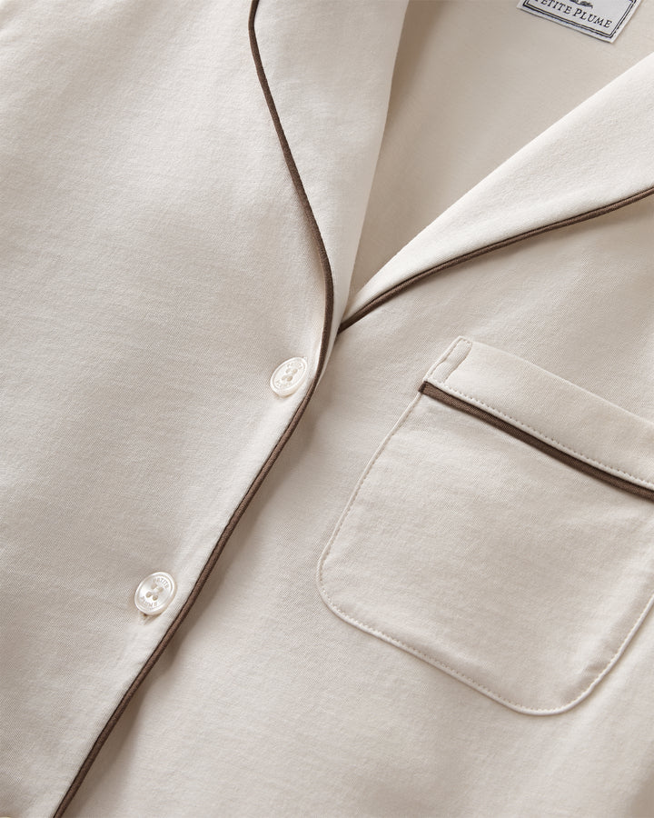 Close up on ivory pajama set with brown piping