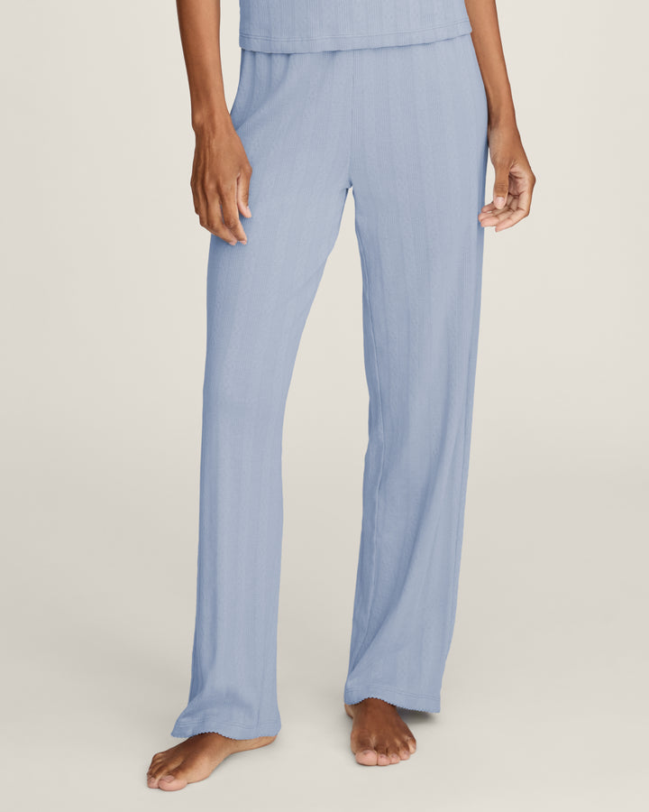 Light blue pants worn by a person on a white background