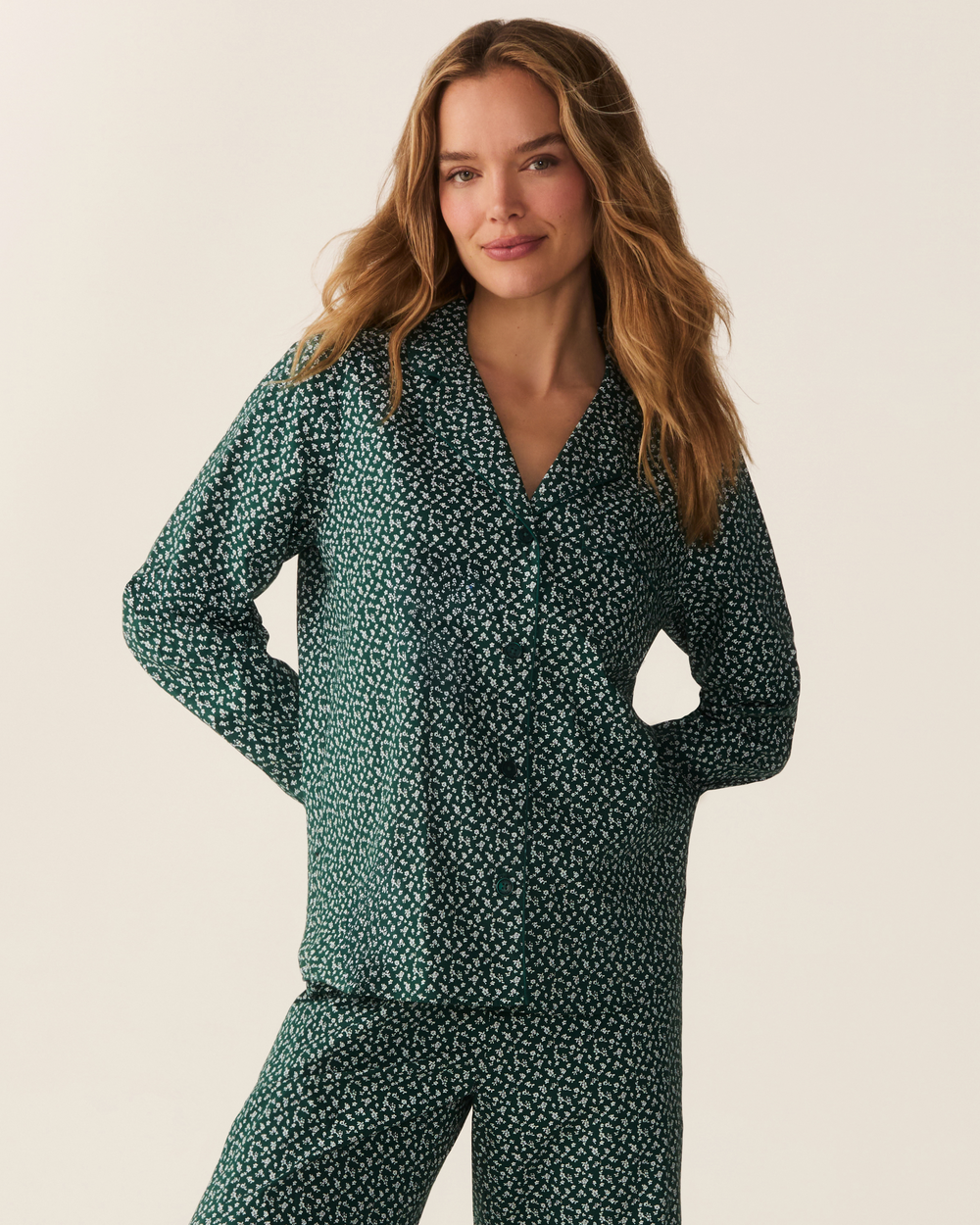 Close up photo of woman wearing green floral two piece pajama set