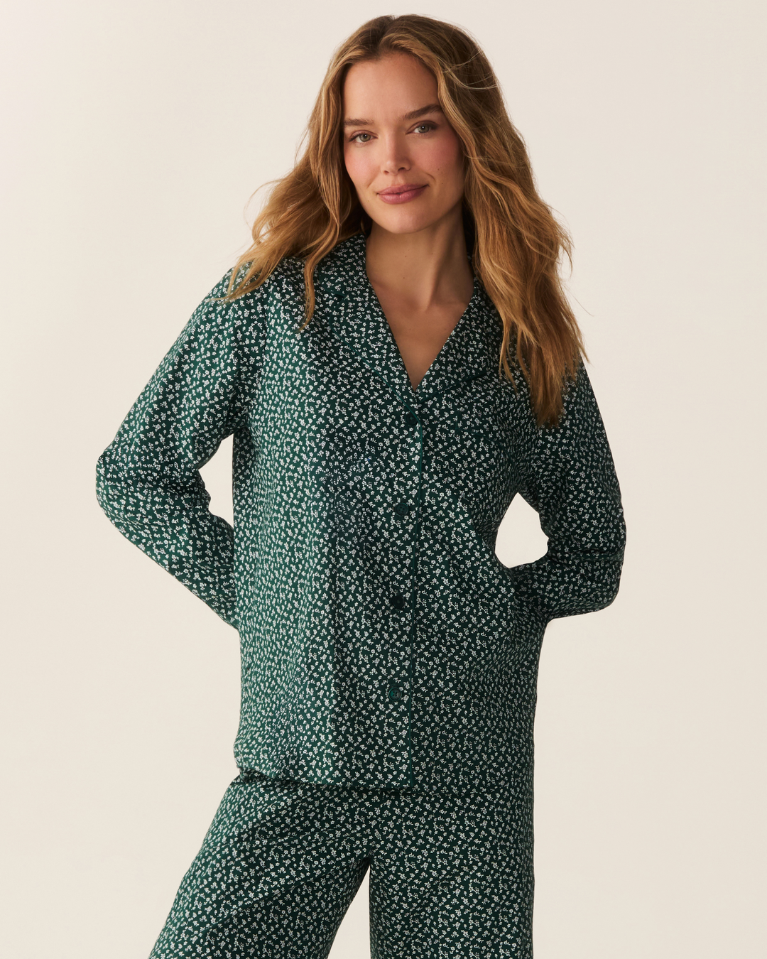 Close up photo of woman wearing green floral two piece pajama set