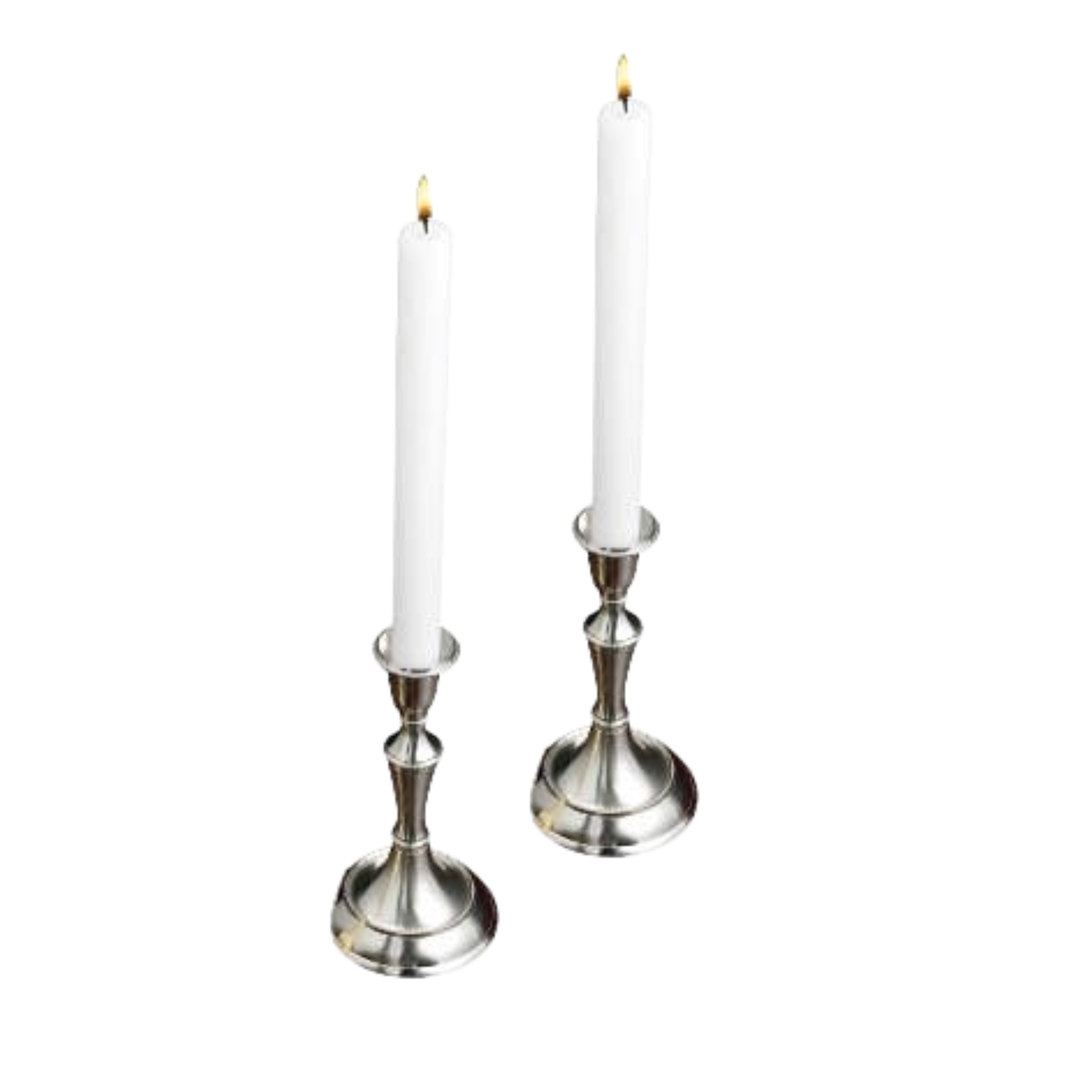Two silver-toned metal candlestick holders with white taper candles, shown on a plain white background.