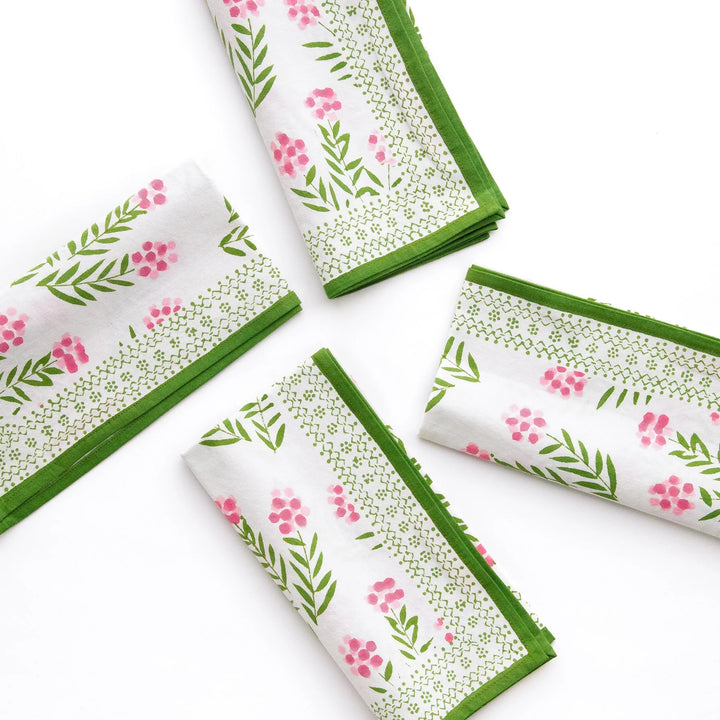 Set of folded napkins with floral pattern on a white background