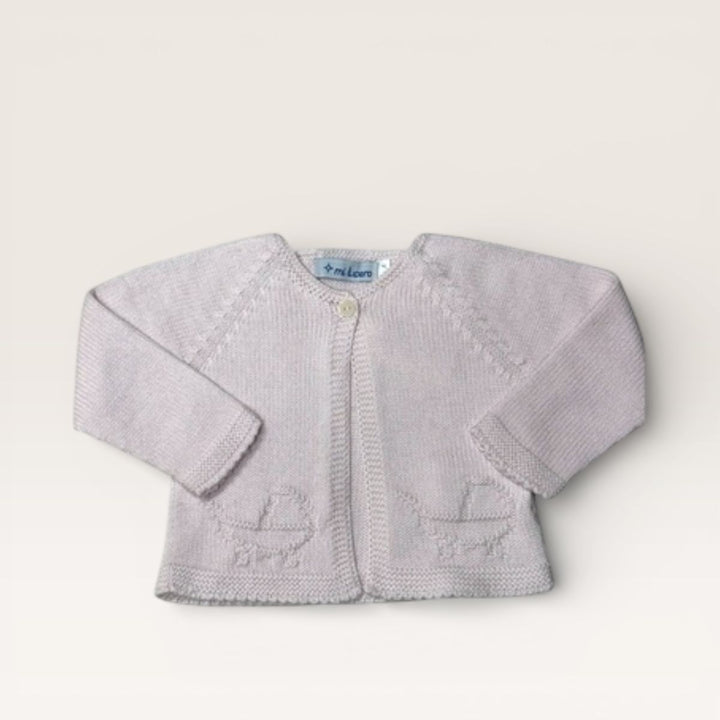 A light pink knit baby cardigan with long sleeves, a button closure, and embroidered motifs on the front, laid flat on a light beige background.