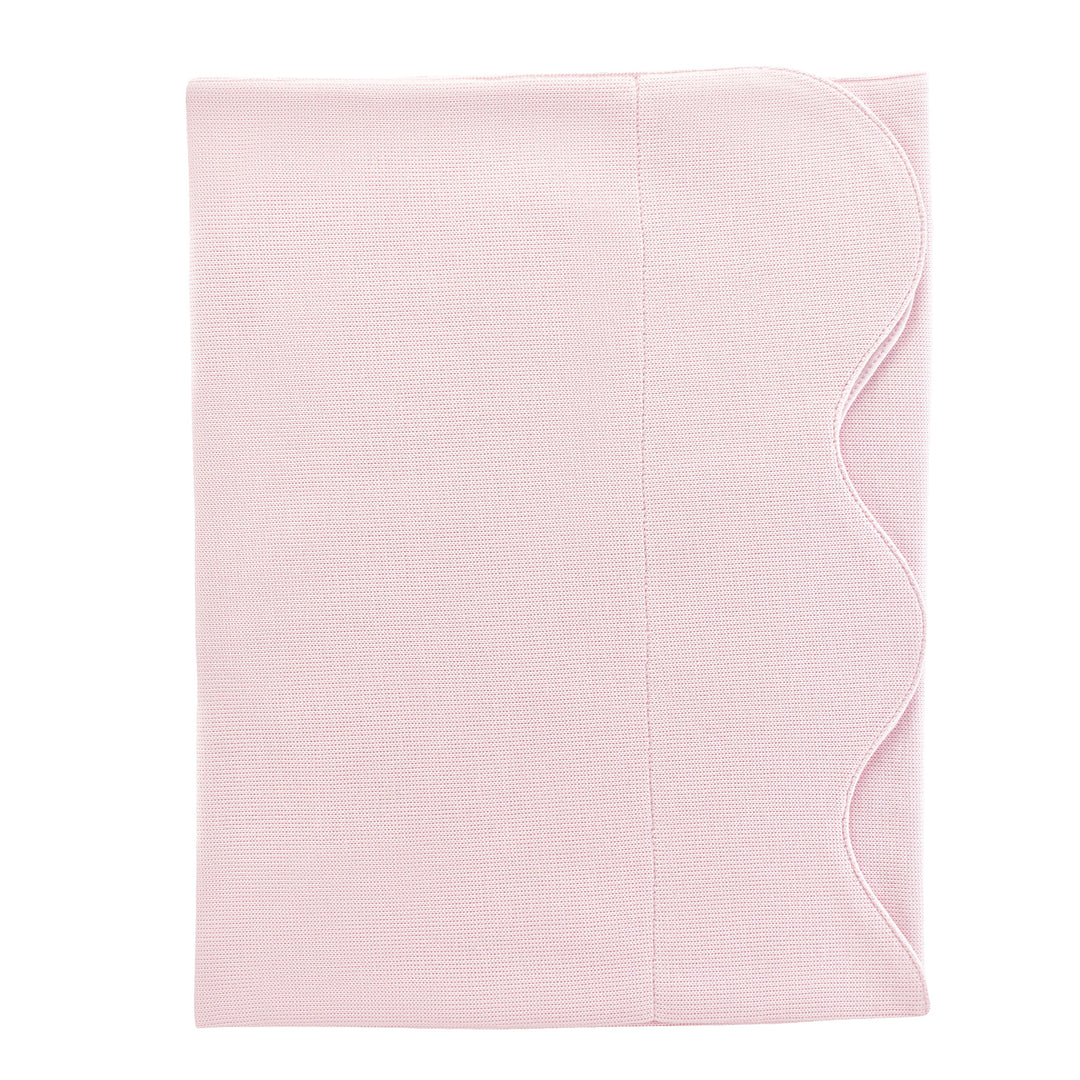 A light pink textured fabric item, likely a baby blanket, swaddle, or muslin cloth, folded neatly with a scalloped edge on the right side, shown against a plain white background.