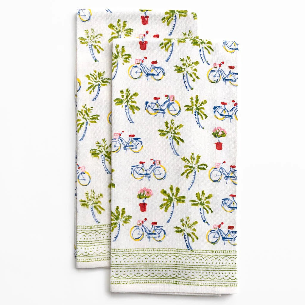 Two kitchen towels with bicycle and flower pattern on a white background