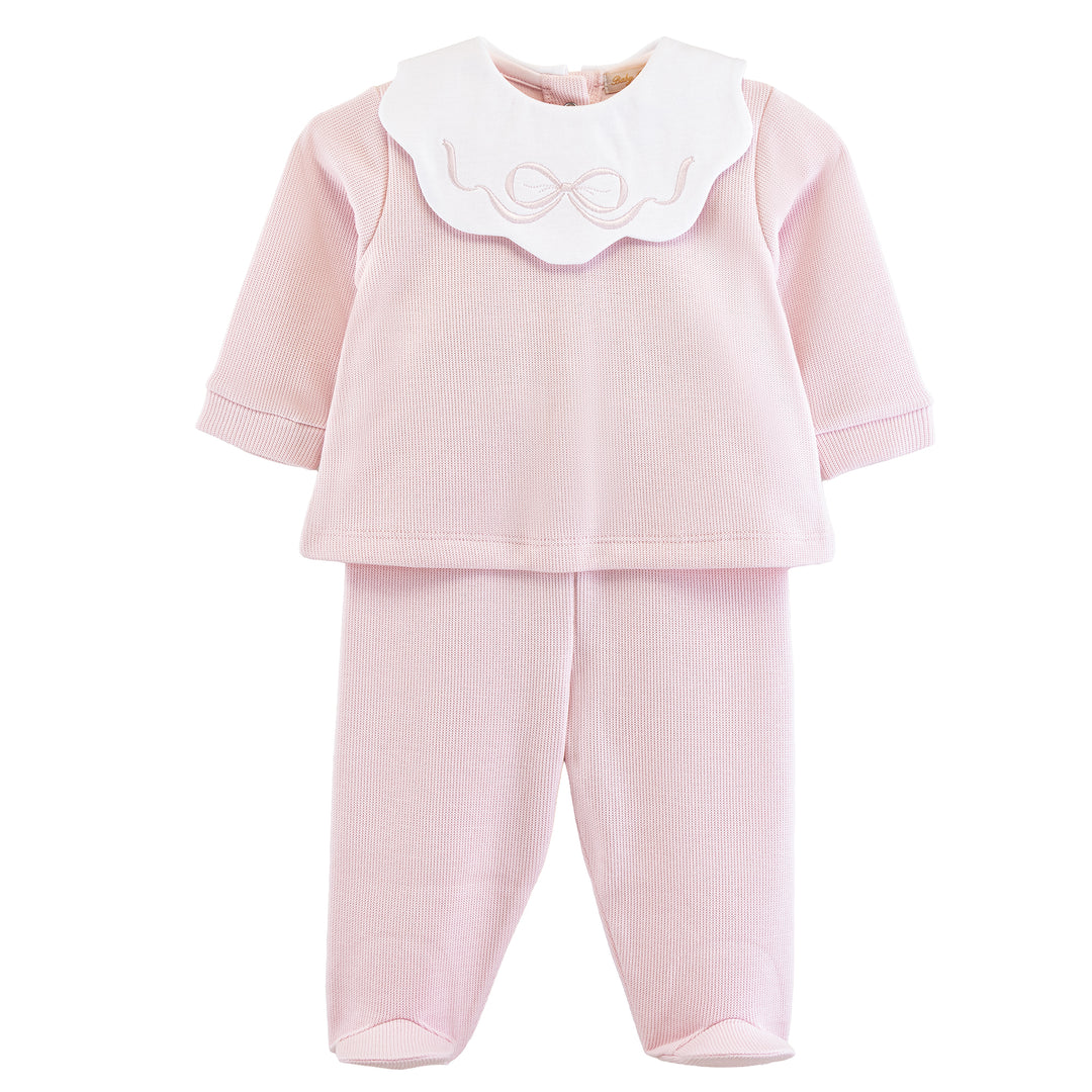 Pink baby outfit with a white collar on a white background