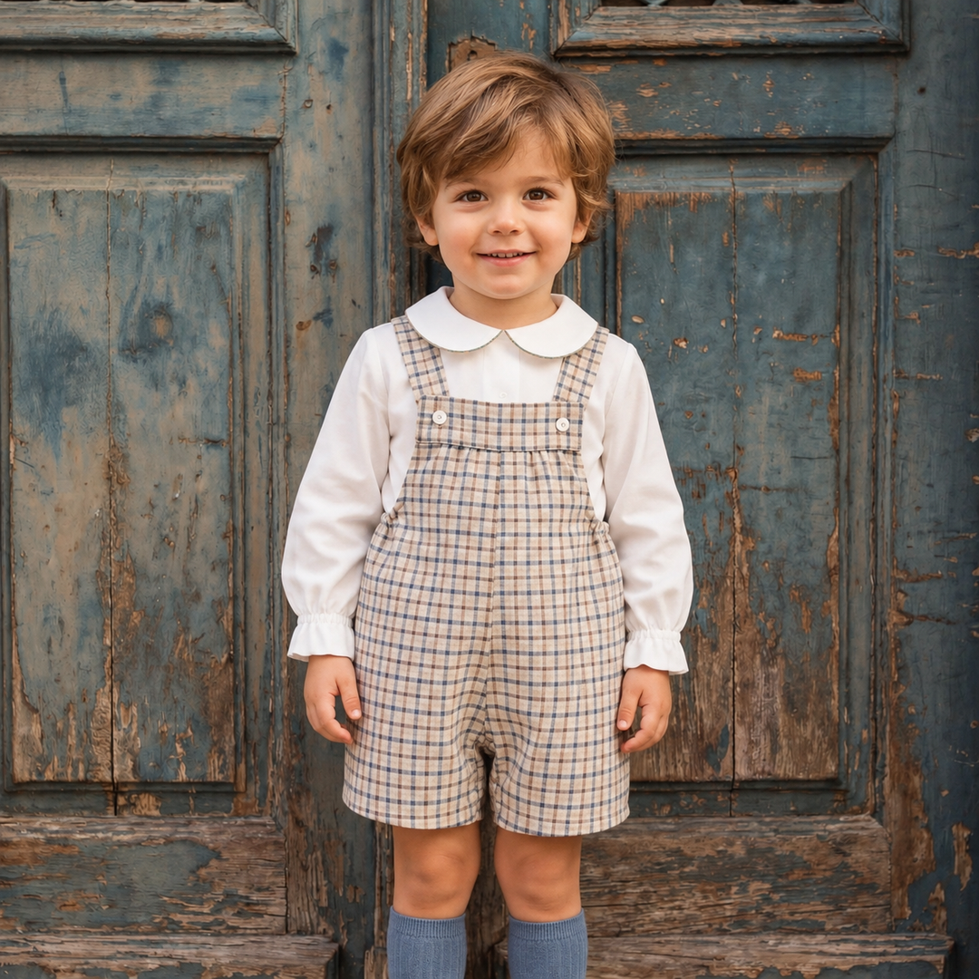 Toddler Boy in Plaid Outfit Standing against a door on a european street