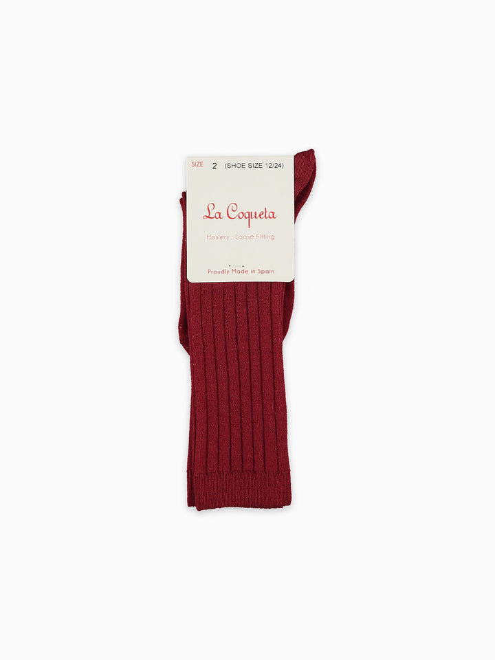 A single ribbed knit sock in deep burgundy red, attached to a white paper brand tag that reads 'La Coqueta'. The sock is photographed flat against a clean, solid white background.