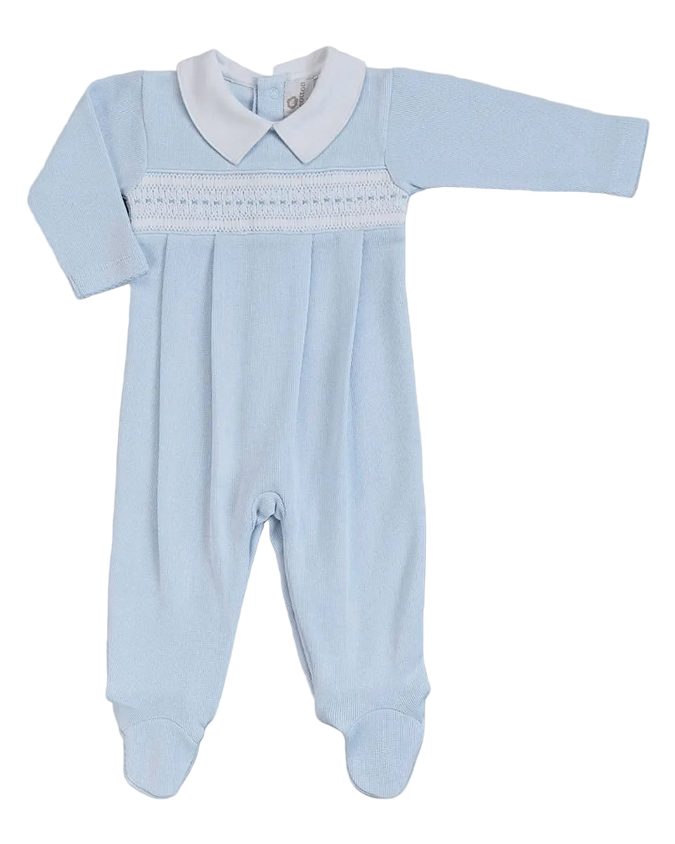 A baby's long-sleeve footed sleeper in light blue with a white pointed collar and white smocked detailing across the chest, displayed flat against a neutral gray background.