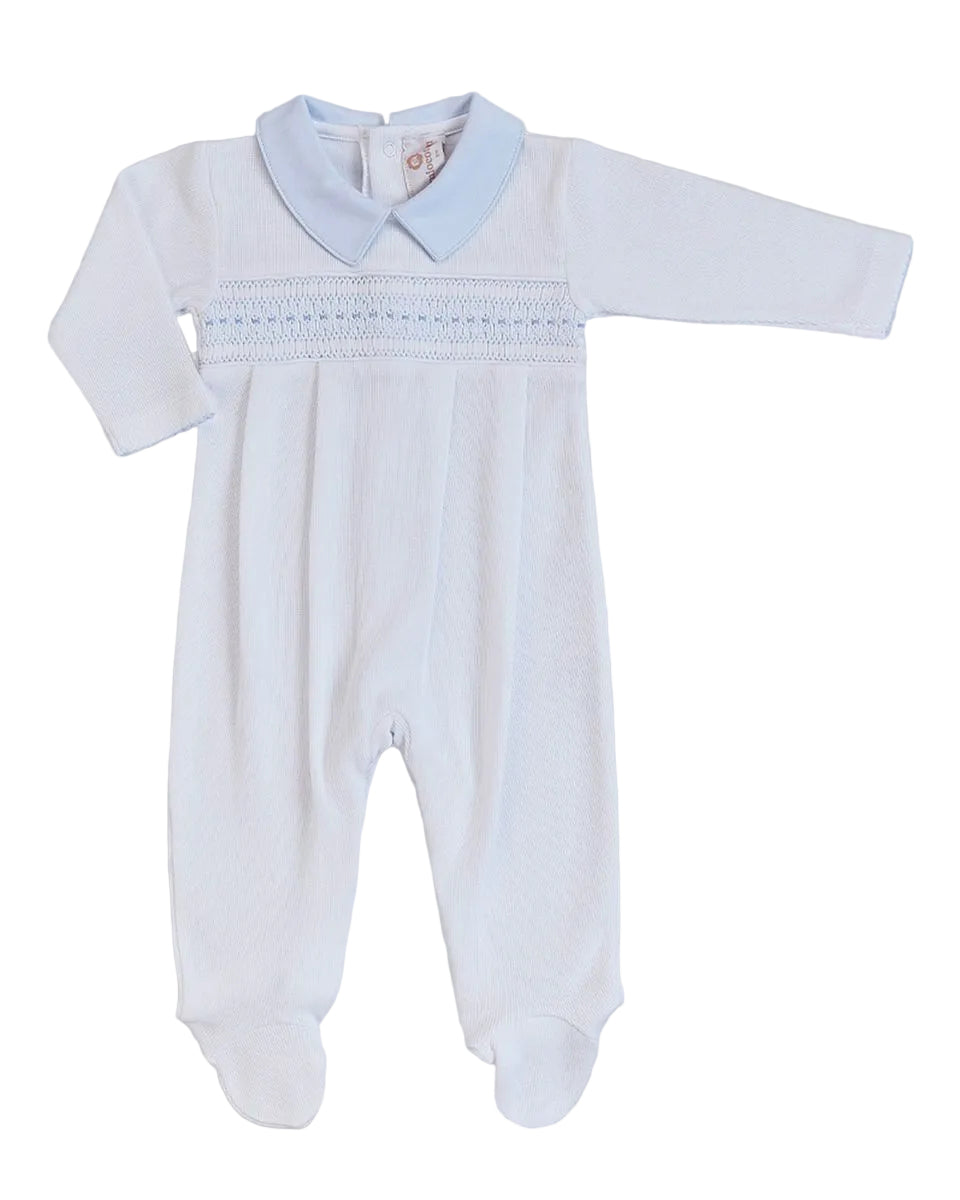 A baby footed sleeper in white with a light blue collar and smocked chest detailing, laid flat on a light gray background.