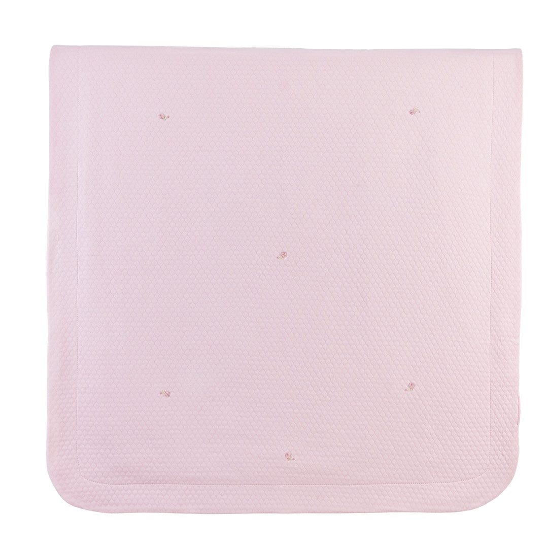 A light pink textured baby blanket with rounded corners and small embroidered dots, shown flat against a white background.