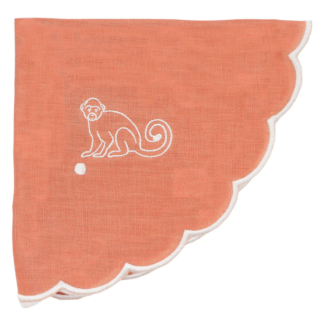 Coral-colored fabric with a white monkey design on a white background