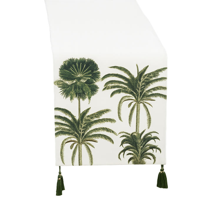 A white table runner featuring a green palm tree pattern, finished with dark green tassels at the bottom, shown against a plain white background.