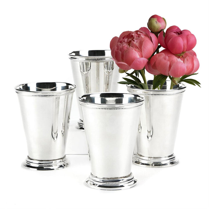 Set of silver mint julep cups with pink flowers on a white background