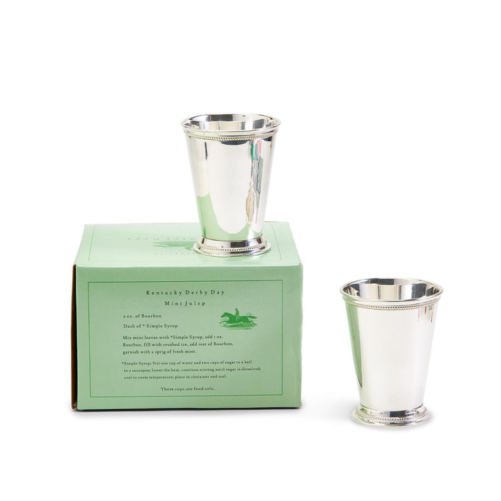 Silver mint julep cups with a green box on a white background