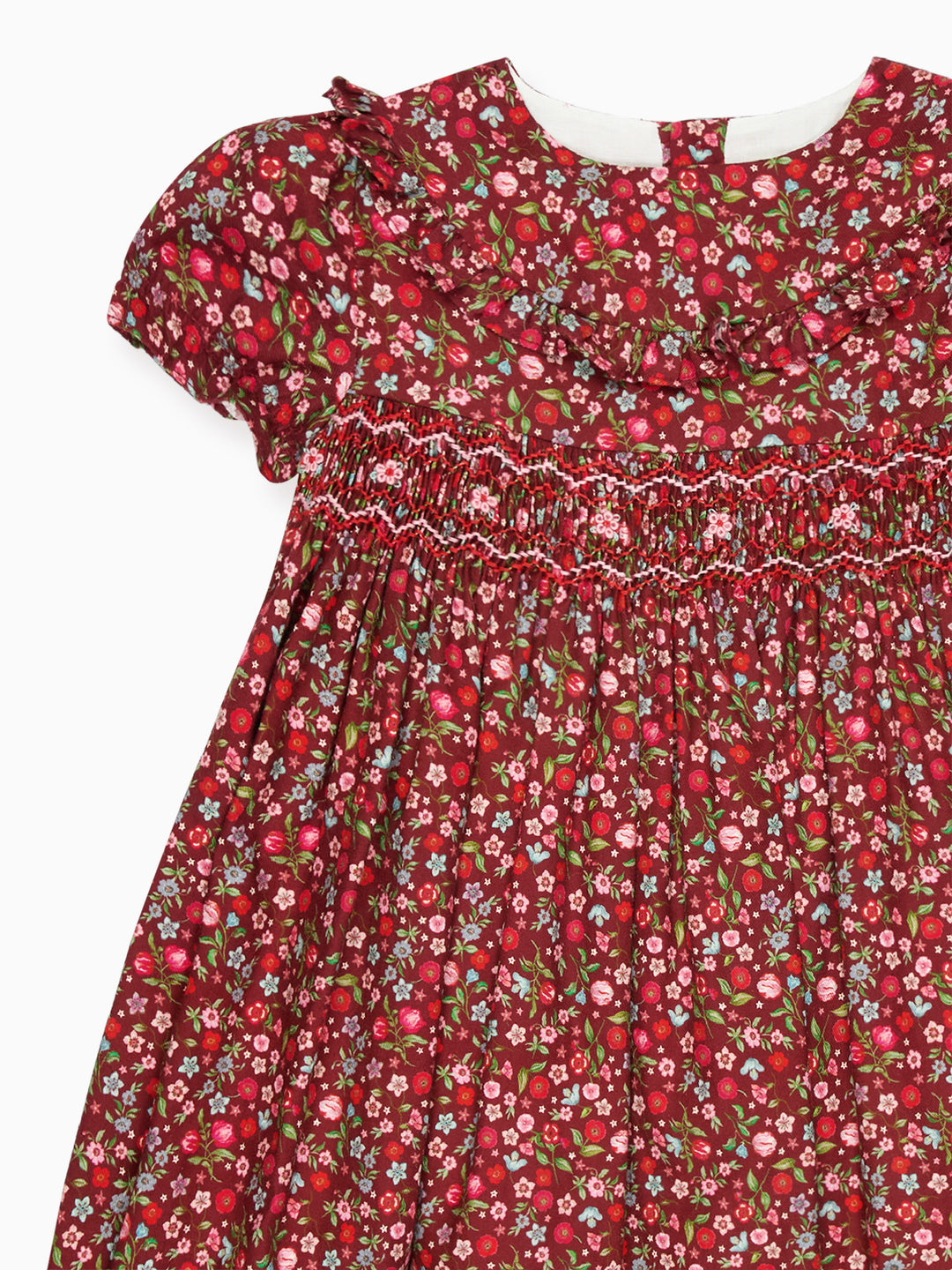 Red floral dress with smocked bodice on a white background