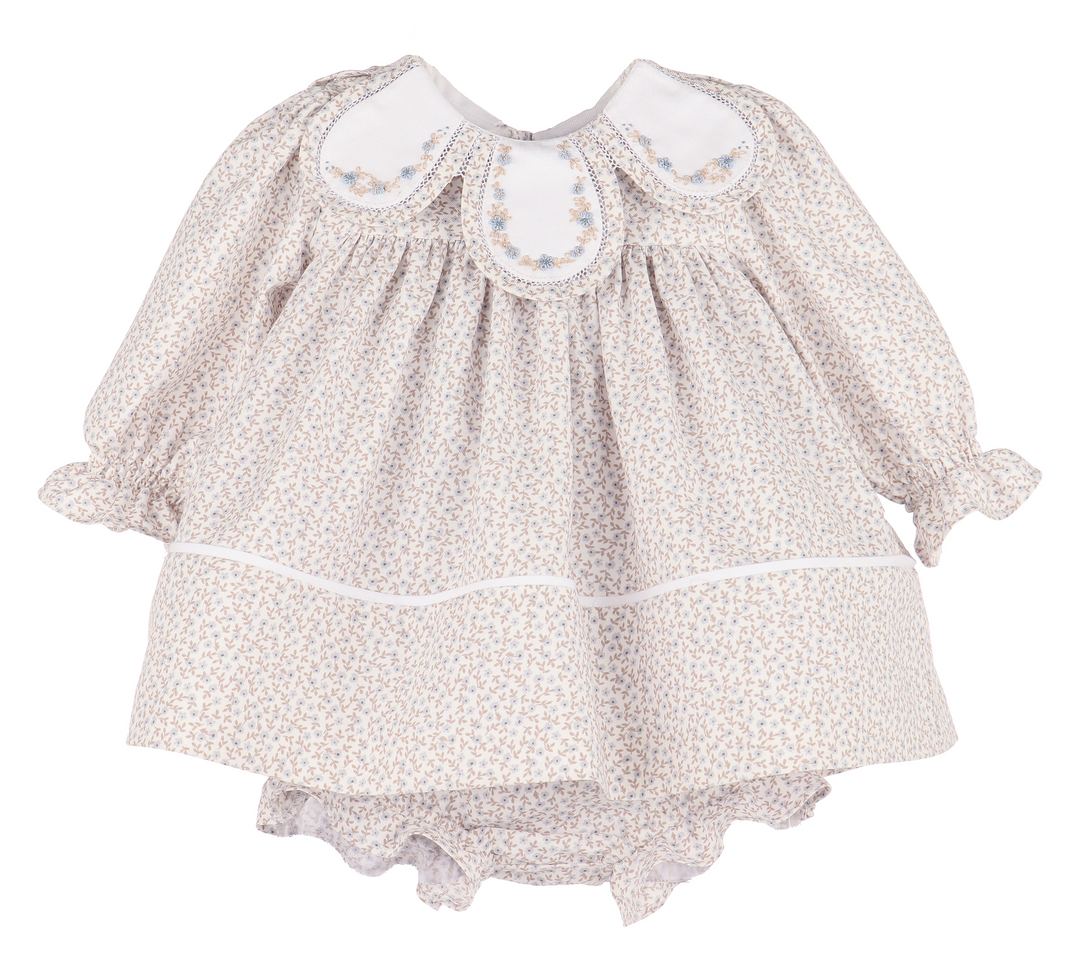 Baby dress with floral pattern on a white background