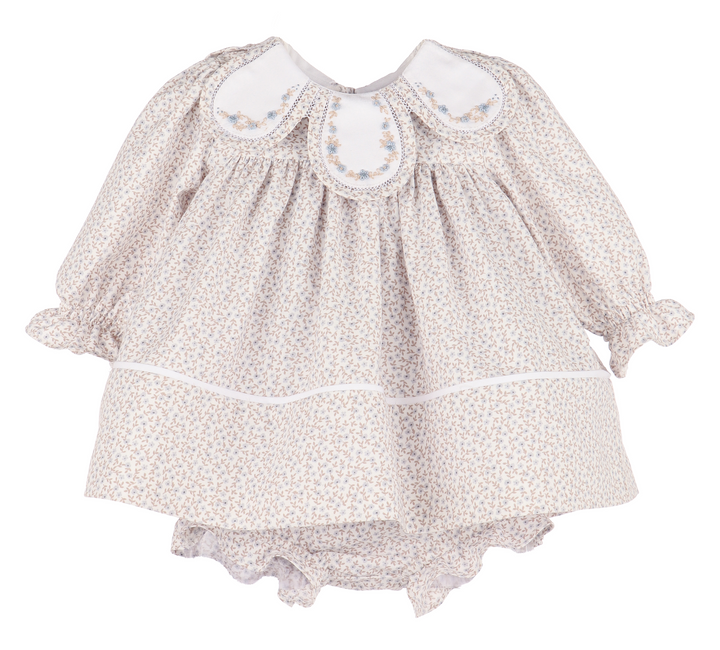 Baby dress with floral pattern on a white background