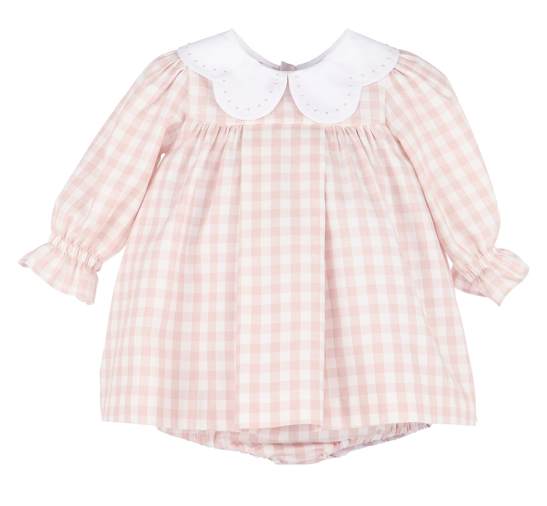 Pink gingham dress with white collar on a white background