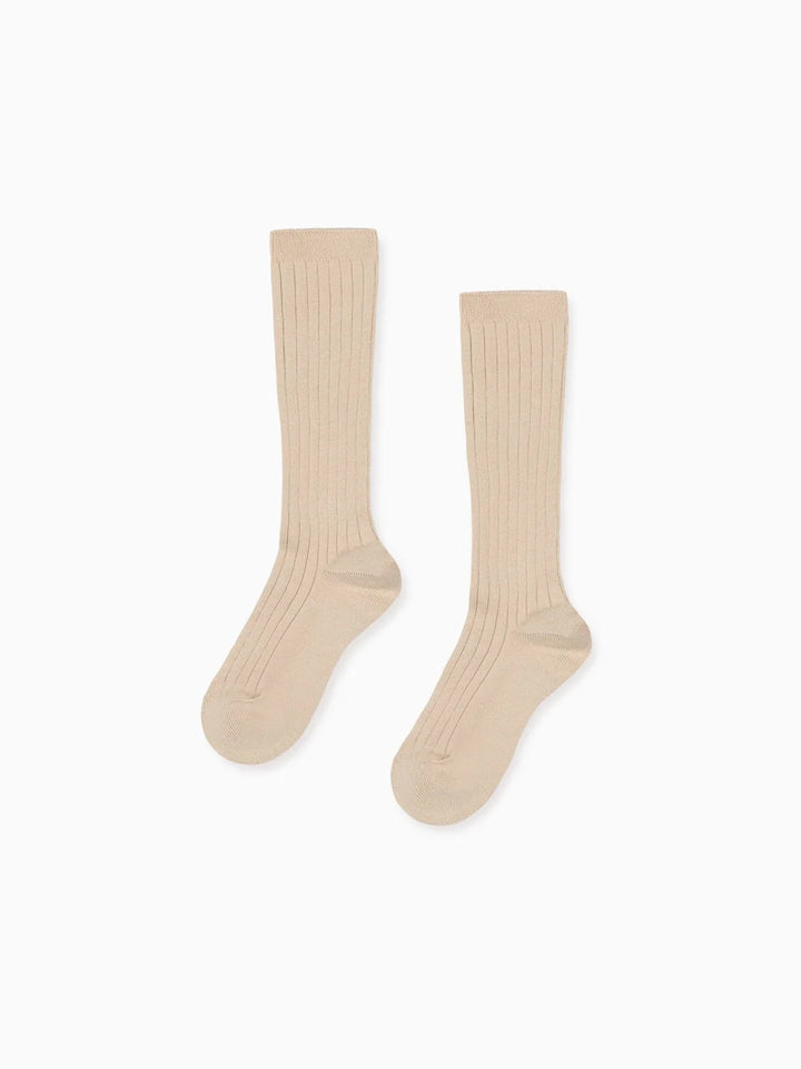 Pair of beige knee-high socks on a white background