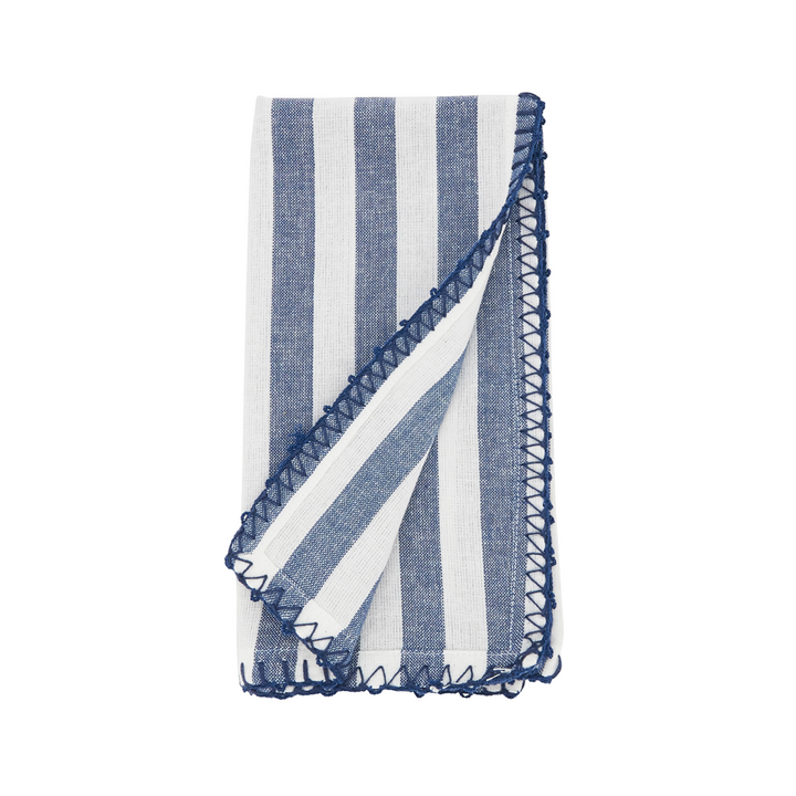 Blue and white striped dinner napkin with ruffled edge on a white background