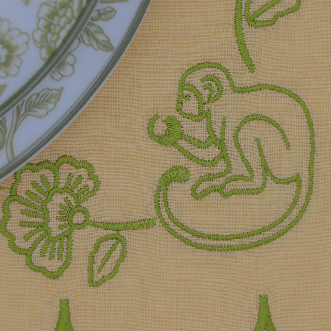 Embroidered monkey shown on a linen placemat