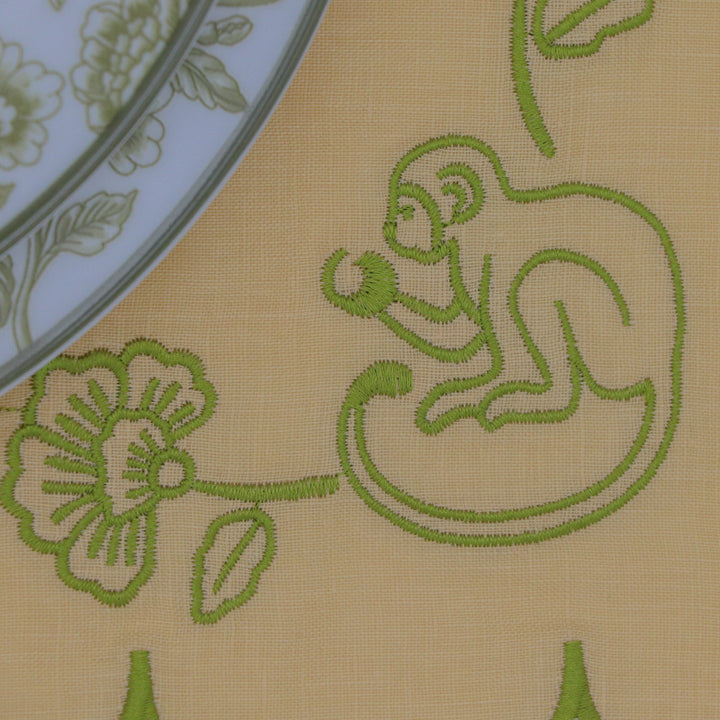 Embroidered monkey shown on a linen placemat