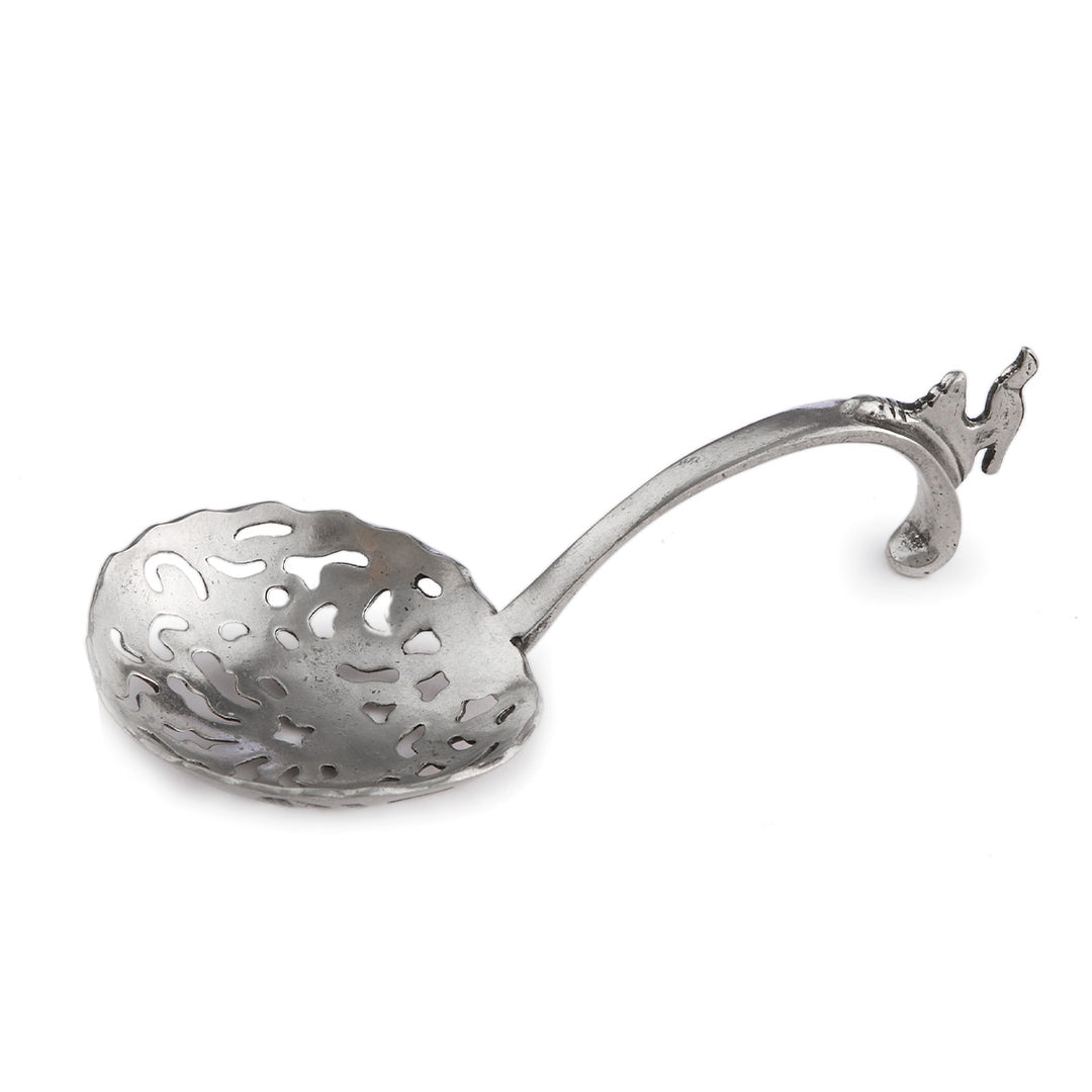 Decorative silver spoon with a detailed handle on a white background