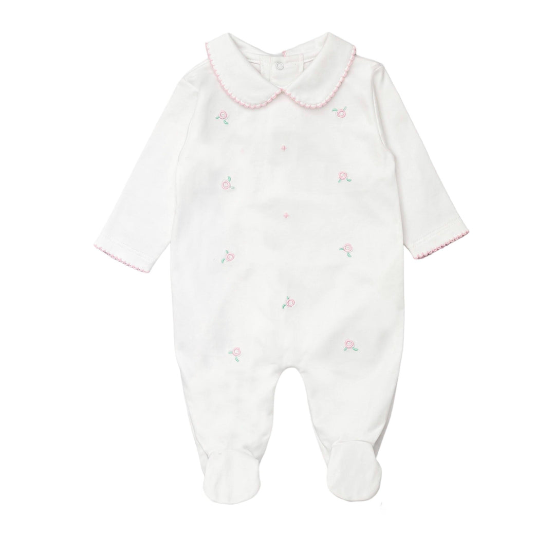 White baby onesie with pink trim and embroidered details on a white background