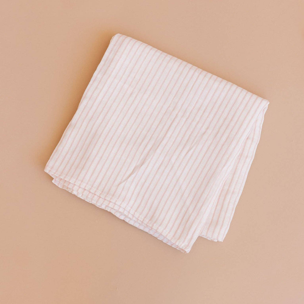pink and cream striped baby blanket folded