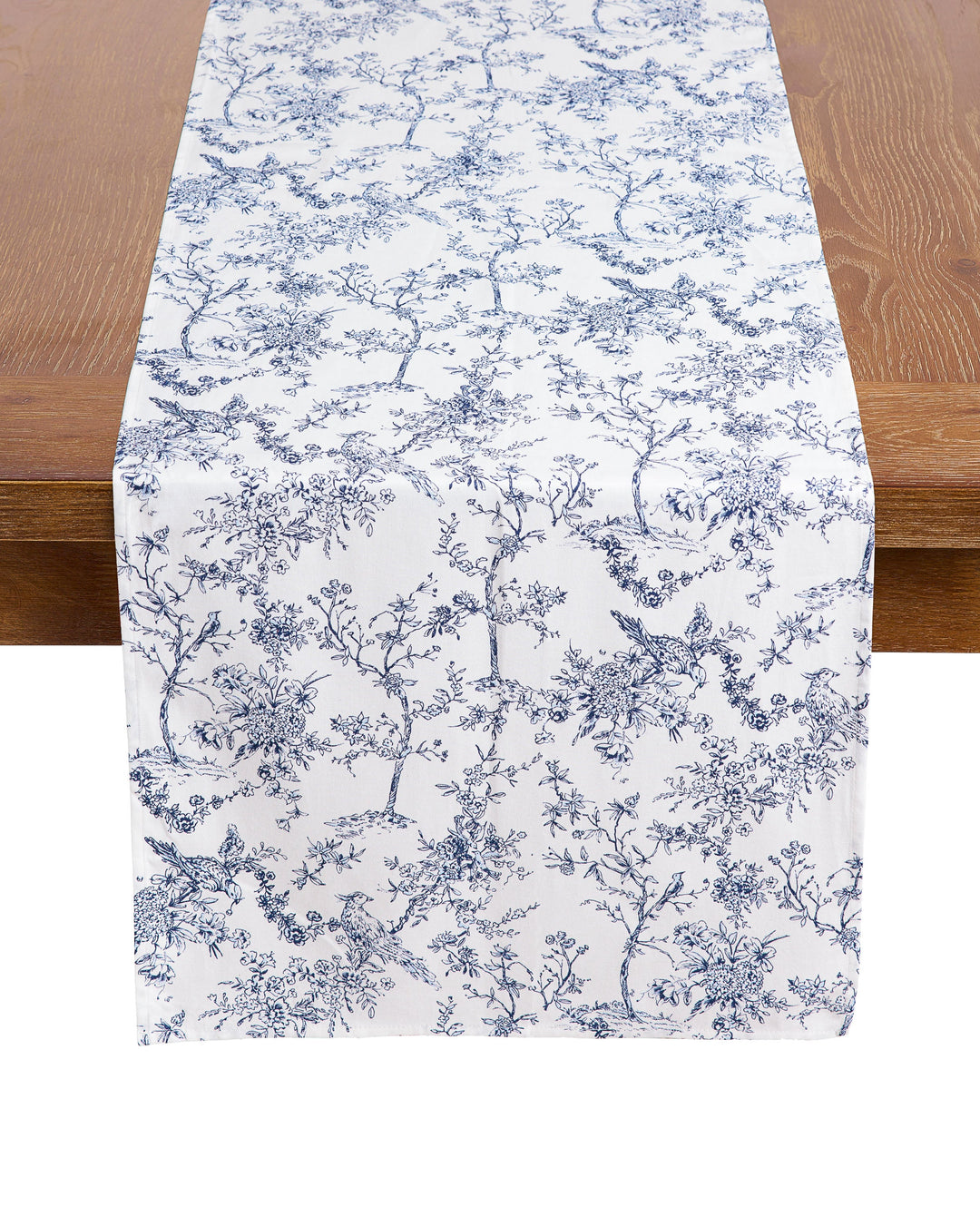 Table runner with blue floral pattern on a wooden table