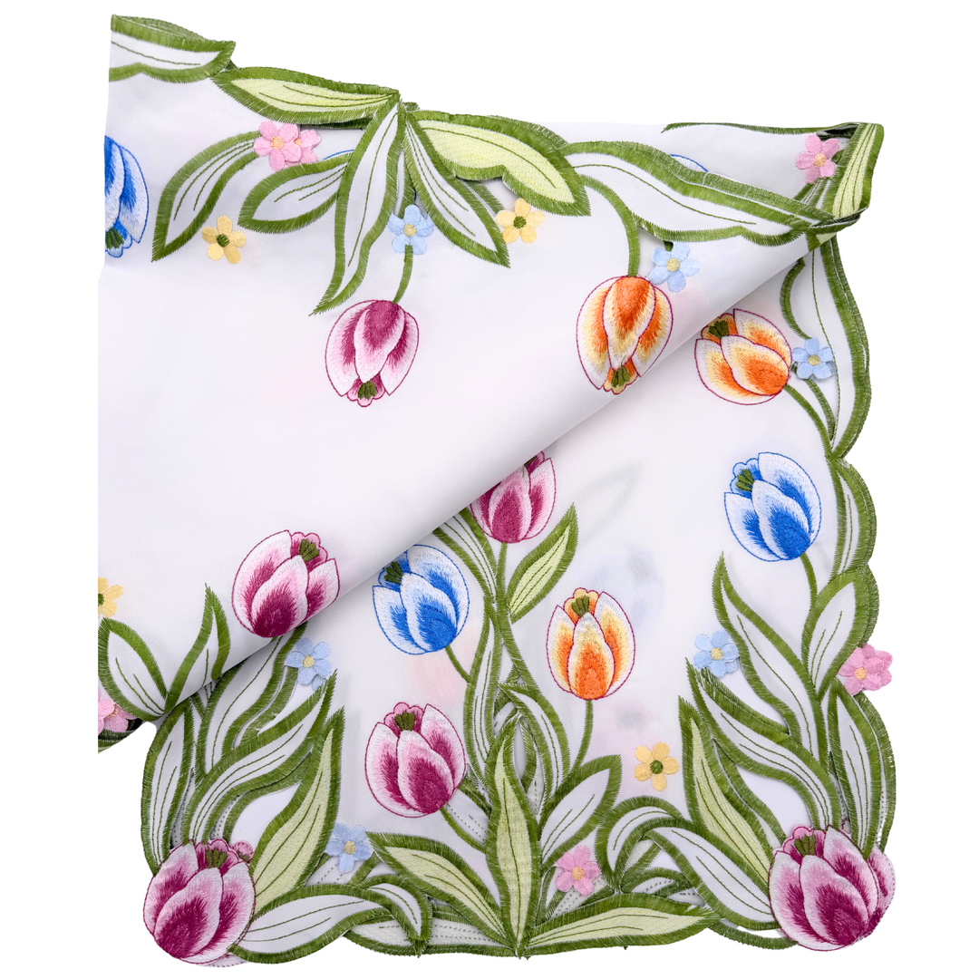Floral patterned fabric with tulips, leaves, and flowers on a white background