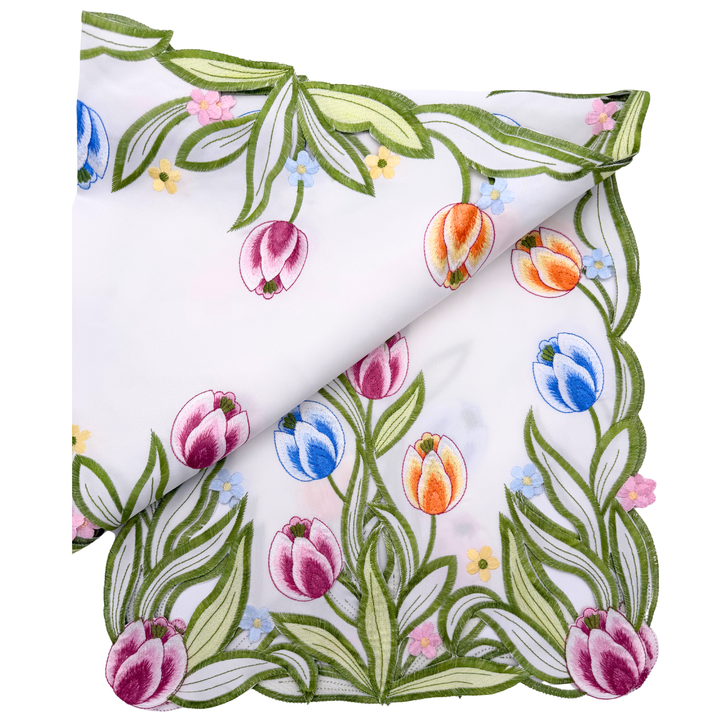 Floral patterned fabric with tulips, leaves, and flowers on a white background