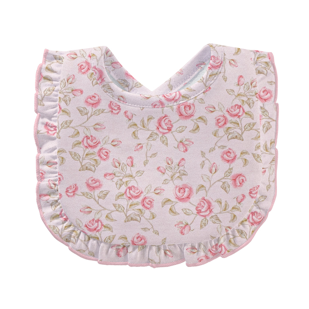 A baby bib with a ruffled edge, featuring a delicate pink rose and green leaf pattern on a pale pink background.