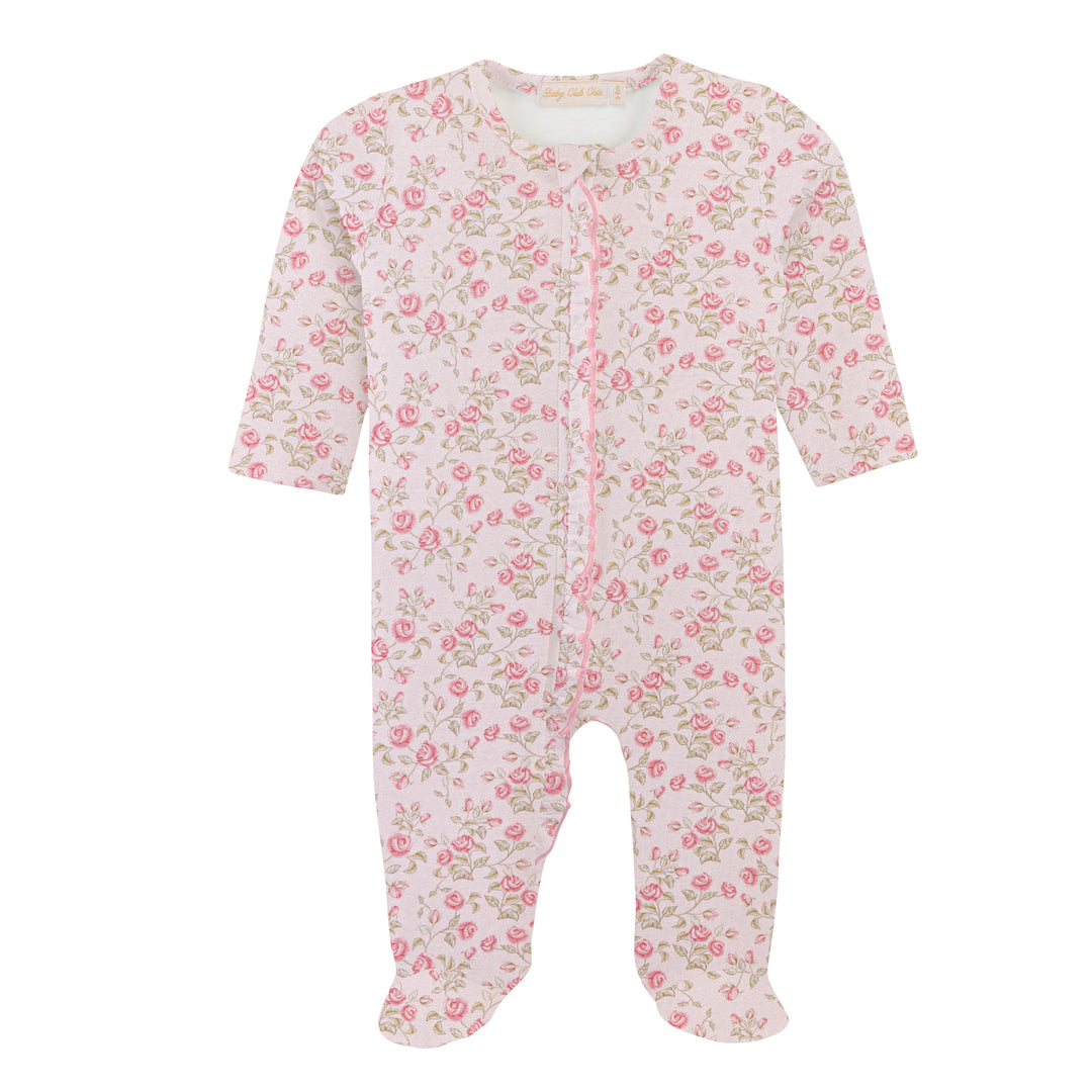 A baby footed sleeper in a light pink and white floral print with green leaves, featuring a front zipper closure.