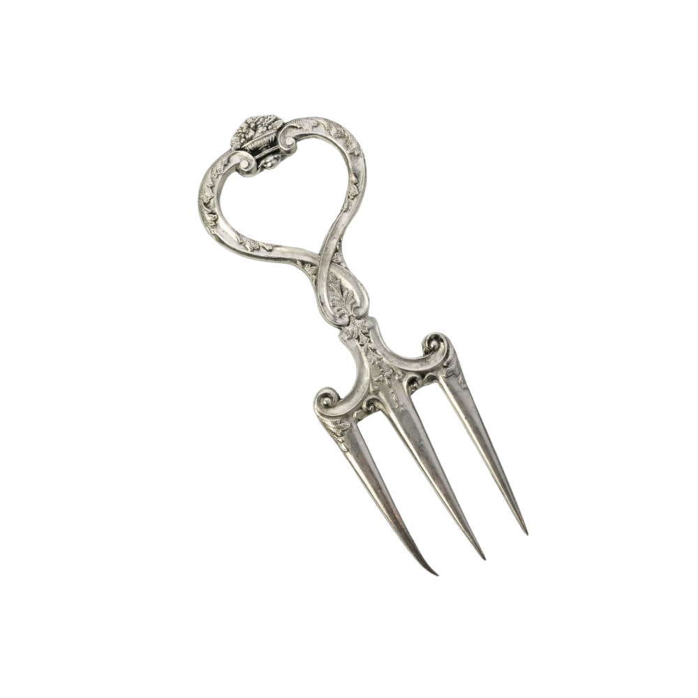 Decorative silver fork with intricate design on a white background