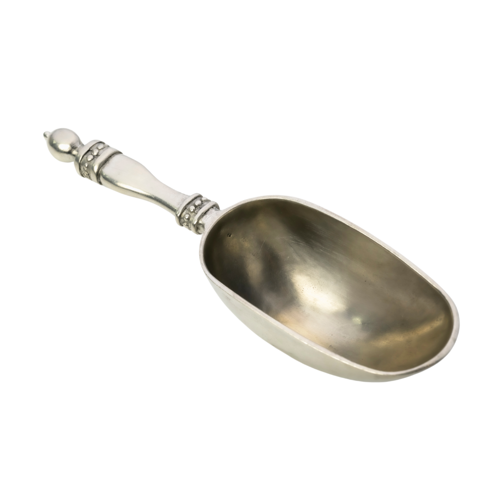 Silver scoop with decorative handle on a white background