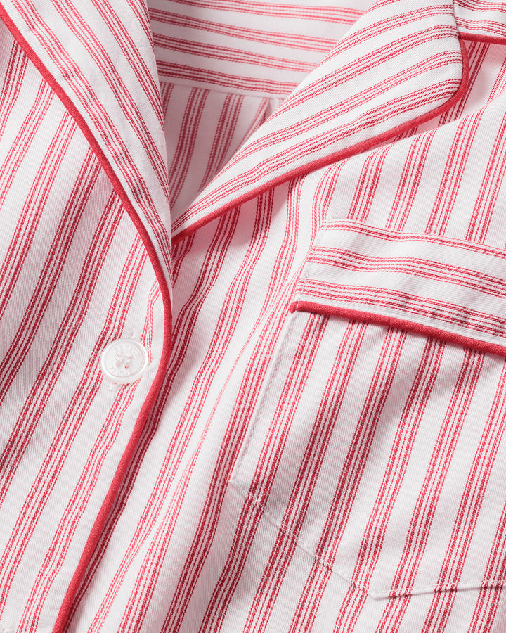 Close-up of a red and white striped shirt with a button.