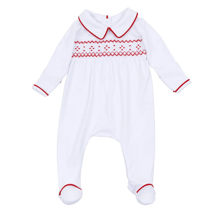 A white baby footed sleeper with long sleeves, a Peter Pan collar, and red embroidered patterns across the chest, finished with red trim on the collar, cuffs, and feet.