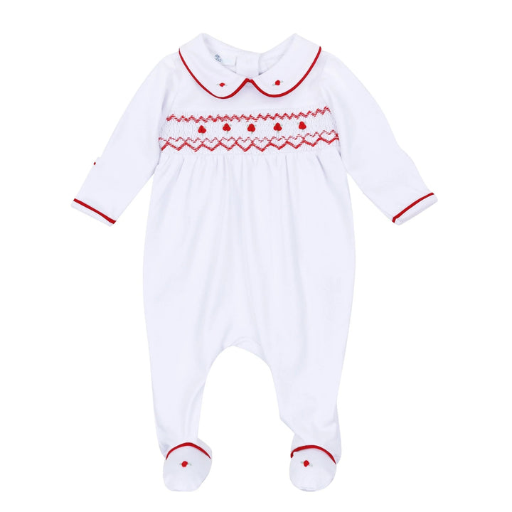 A white baby footed sleeper with long sleeves and a Peter Pan collar, featuring red embroidered patterns across the chest and red trim on the collar, cuffs, and feet.