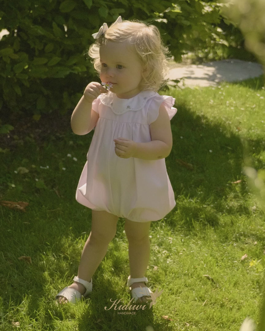 Girl Pink Romper with Embroidered Flowers outside 